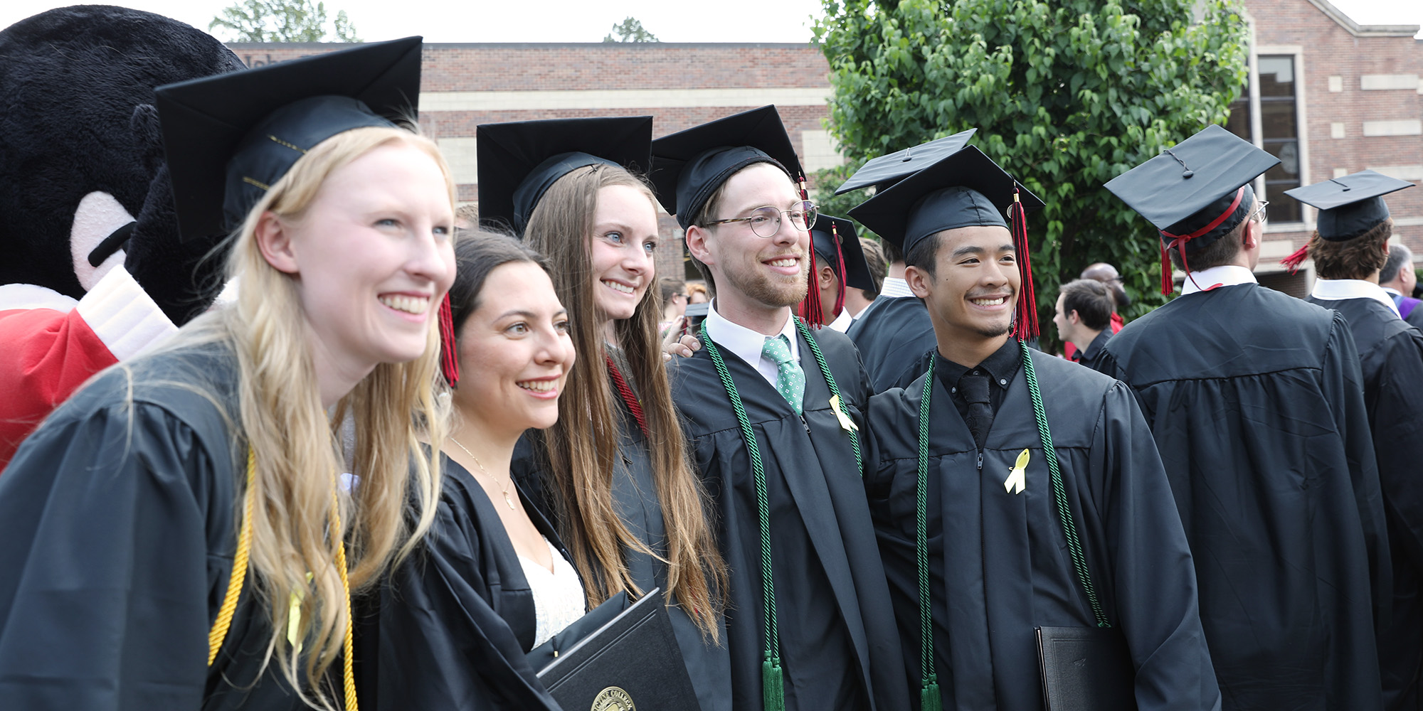 Graduates pose for a photo after Commencement