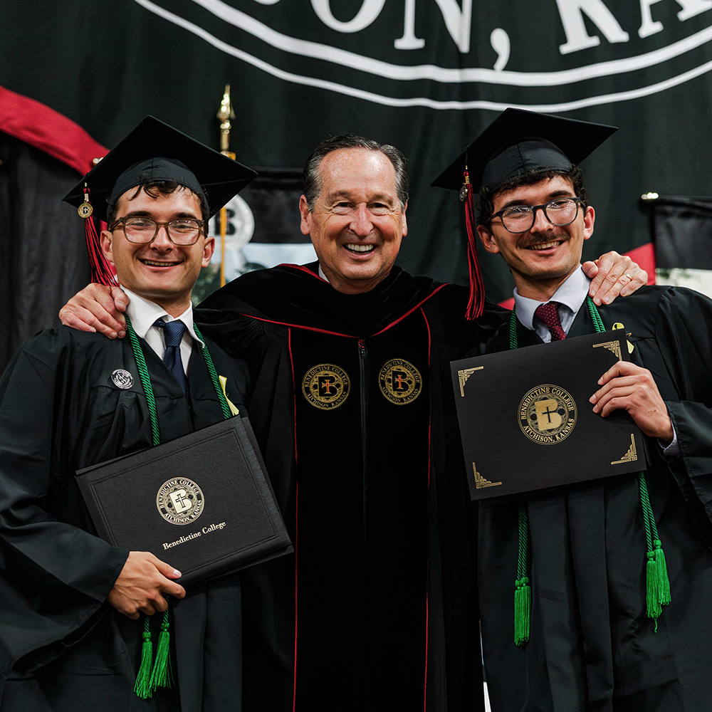 President Minnis with two graduates at the Commencement ceremony