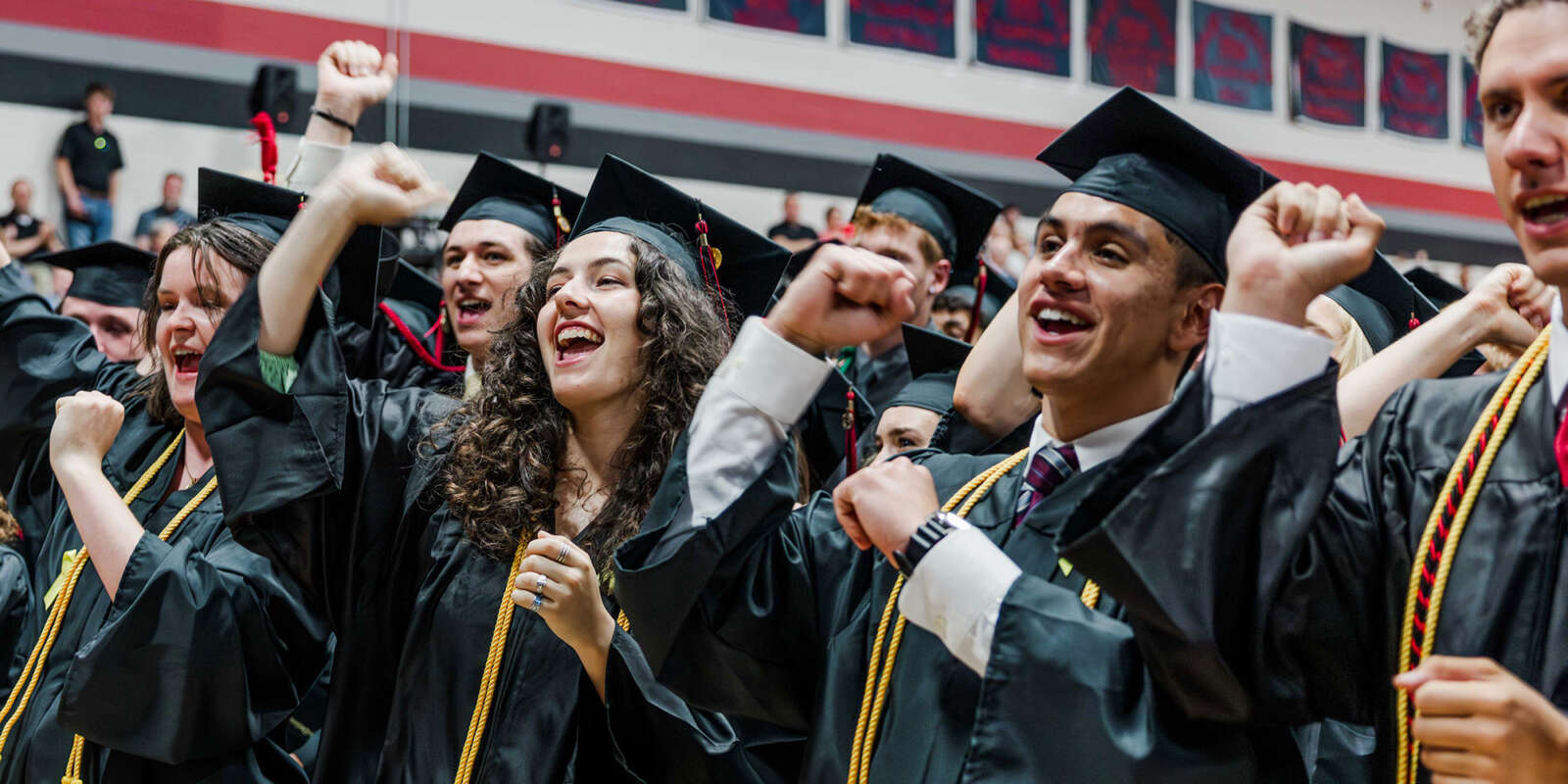 Graduates cheering at the Commencement ceremony