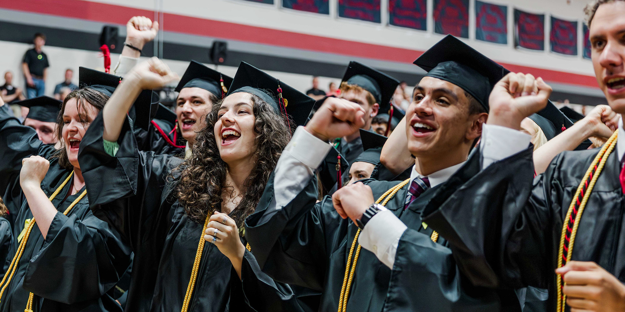 Graduates cheering at the Commencement ceremony