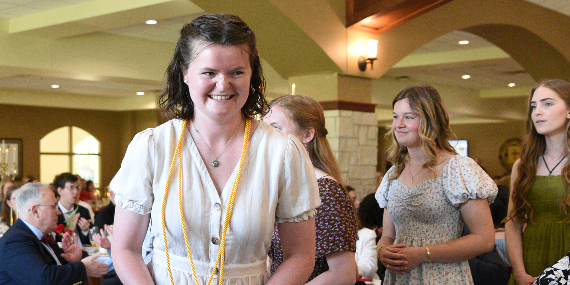 A graduate after receiving her honor cord at the Champagne Brunch