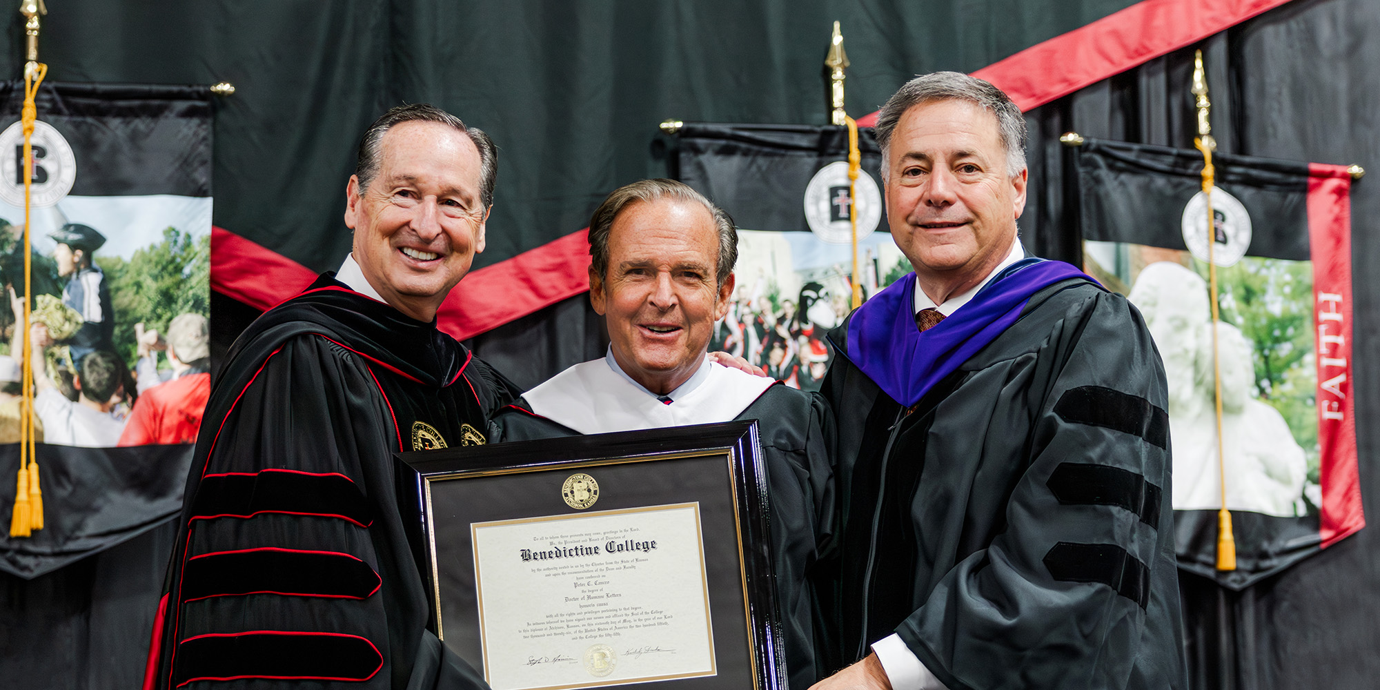 Peter Cancro, 2026 Commencement Speaker, poses for a photo with President Stephen Minnis and Benedictine College Chair of the Board Mike Kuckelman