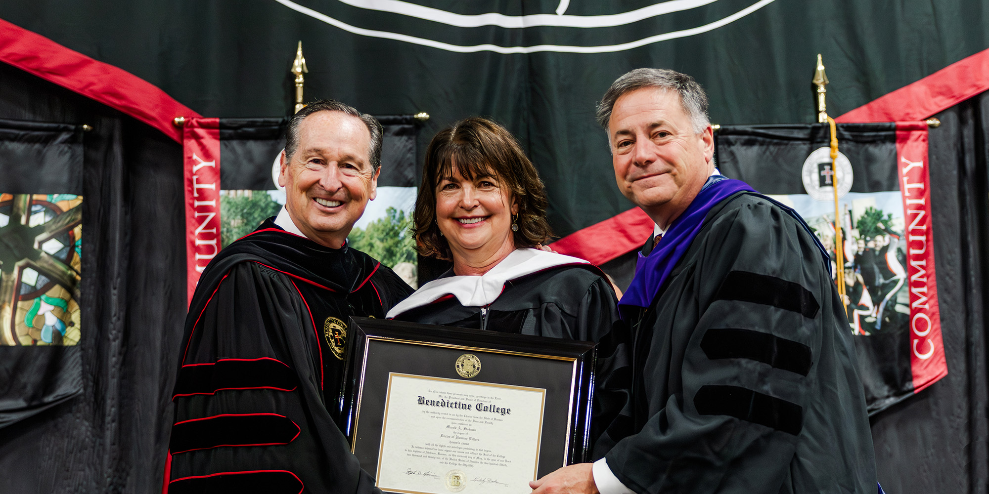 Marcie Stokman, 2026 Honorary Doctorate of Humane Letters recipient, poses for a photo with President Stephen Minnis and Benedictine College Chair of the Board Mike Kuckelman