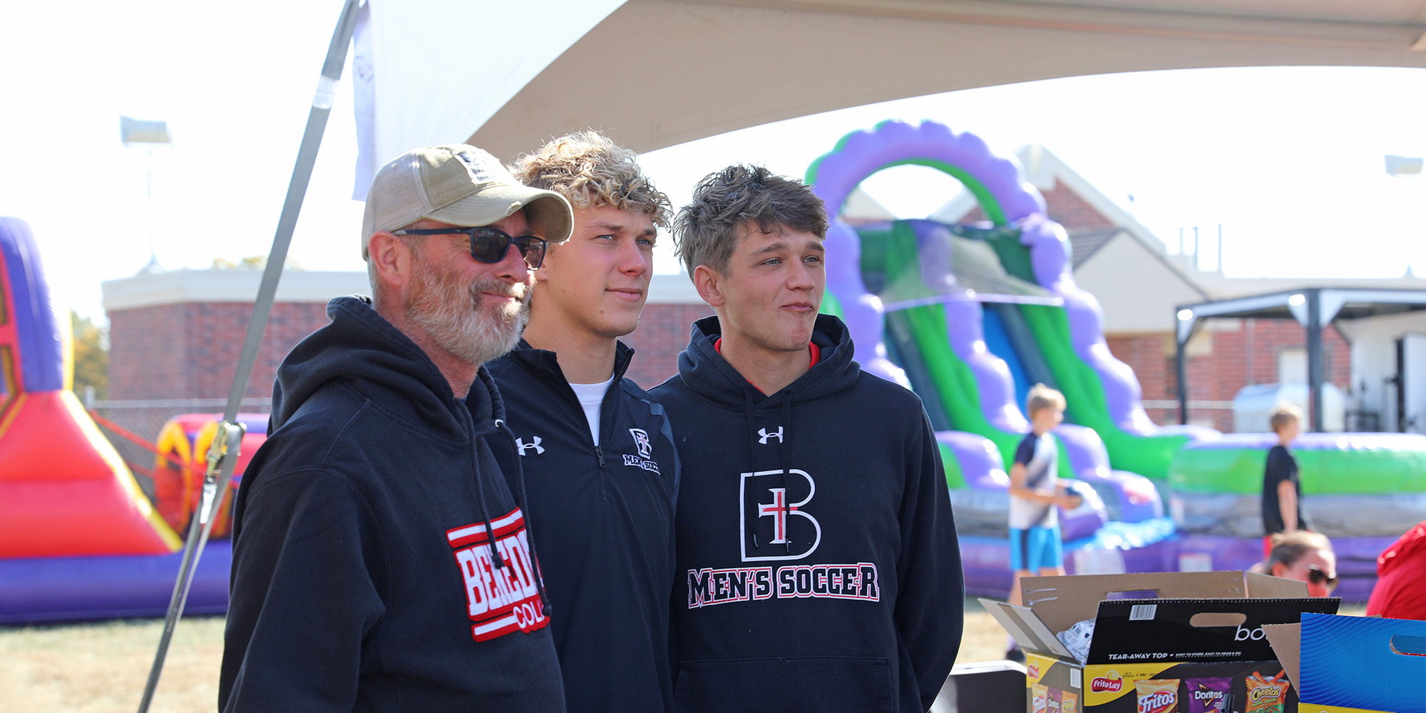 Family members pose for a photo at Alumni Alley during Homecoming