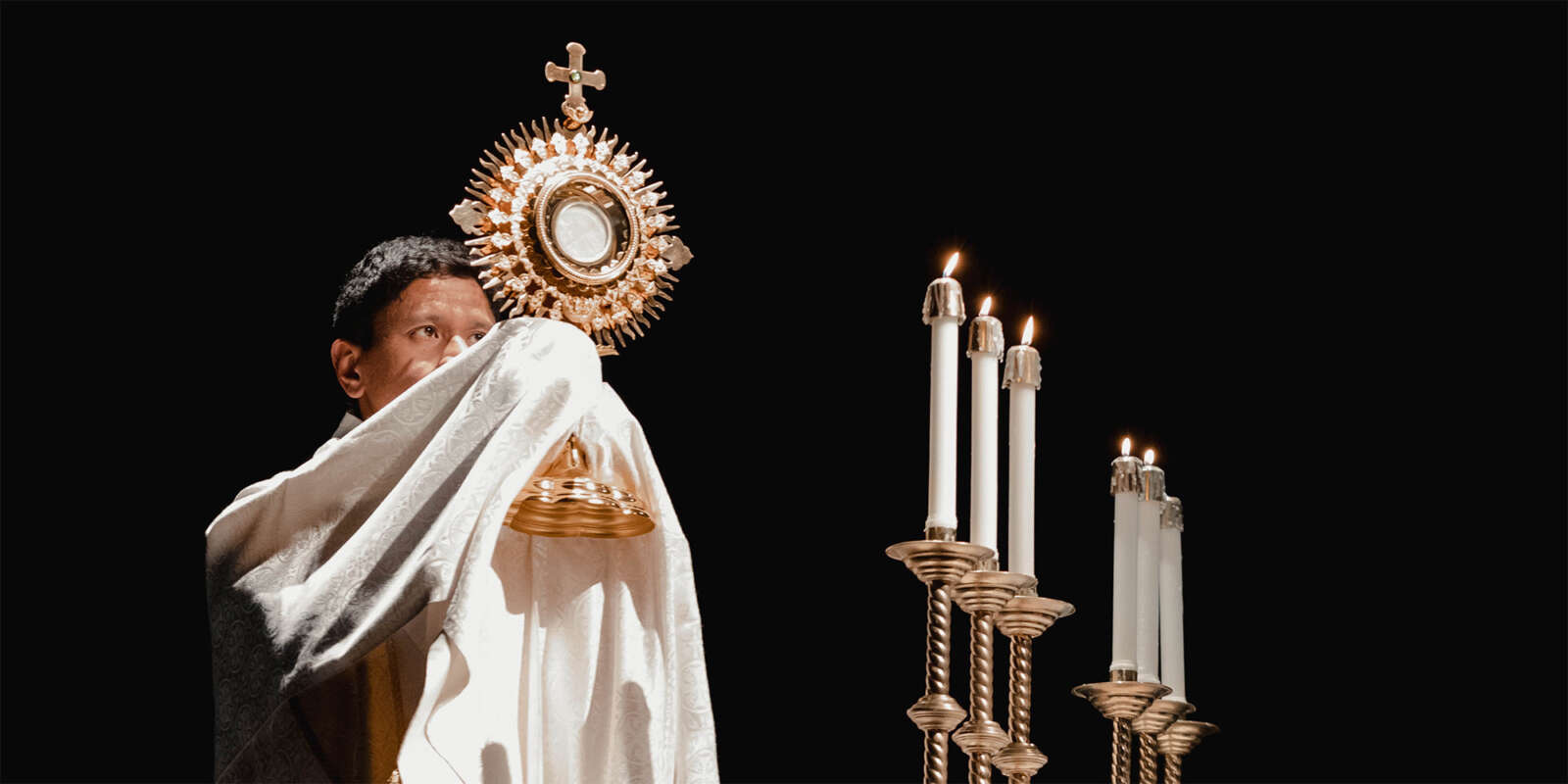 A priest elevates the Monstrance during Eucharistic Adoration