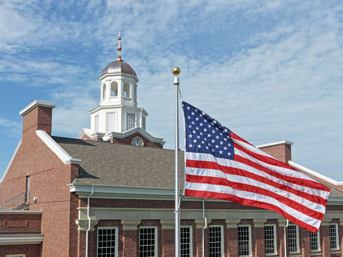 The tower of the Moritz Library in D’Aniello Hall with the American Flag in the foreground