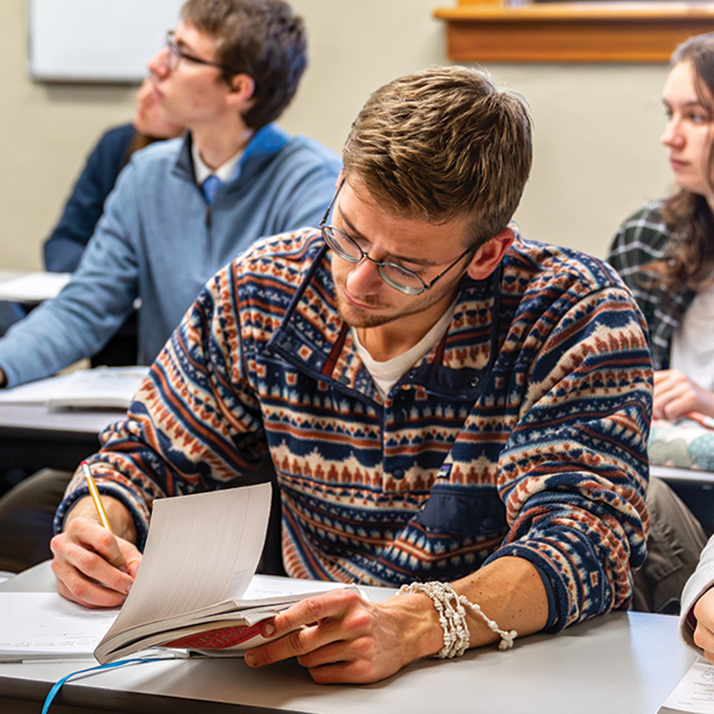 A student takes notes in class