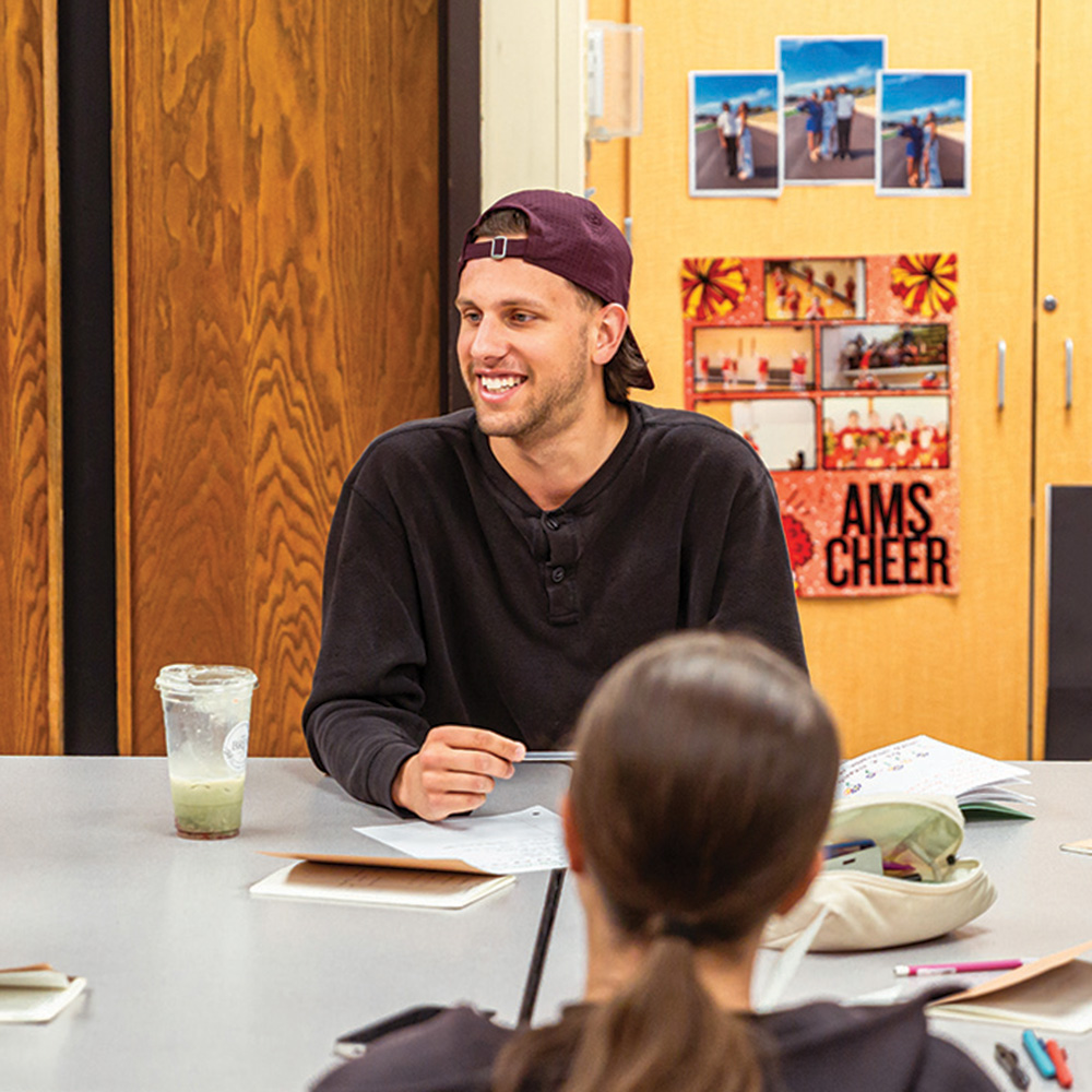 A student teacher working with middle school students