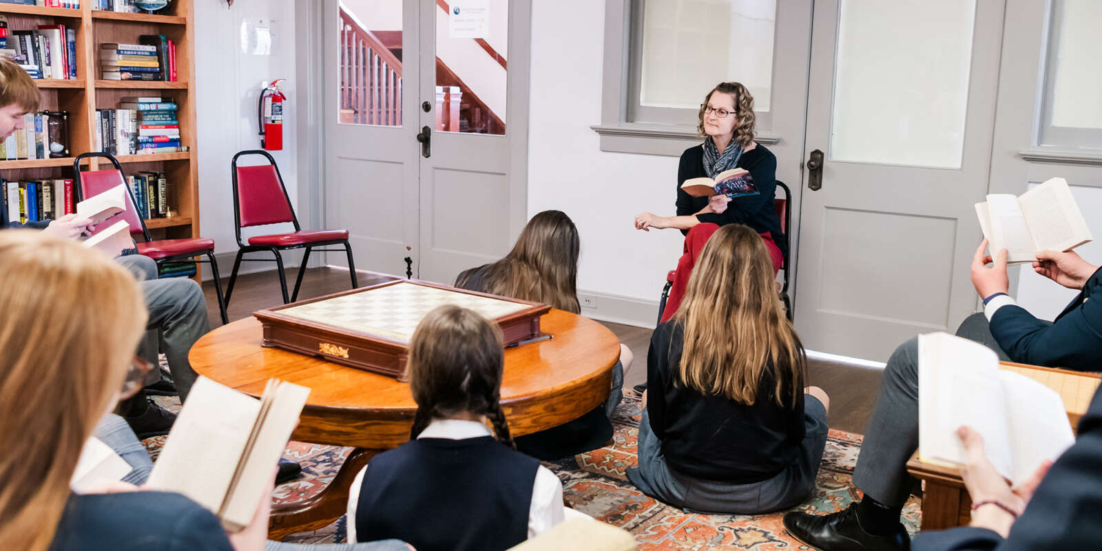 A teacher leads a reading group at a school