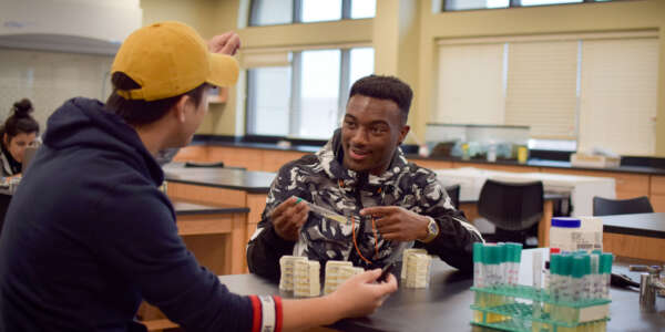 Two students work in a lab