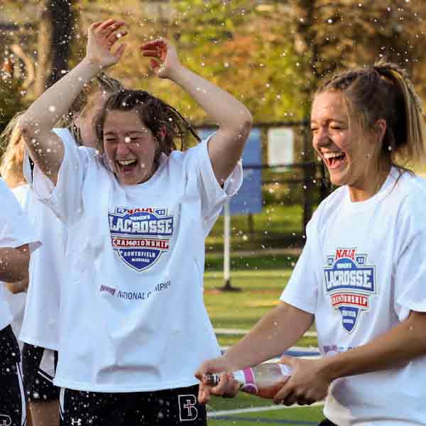 The Women's Lacrosse team celebrates with a drink after the 2022 NAIA Women's Lacrosse Championship game