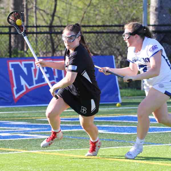 A Benedictine College Women's Lacrosse player in possession of the ball