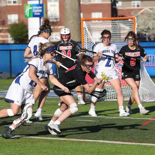 A Benedictine College Women's Lacrosse player fights to keep the ball during the 2022 NAIA Women's Lacrosse Championship game